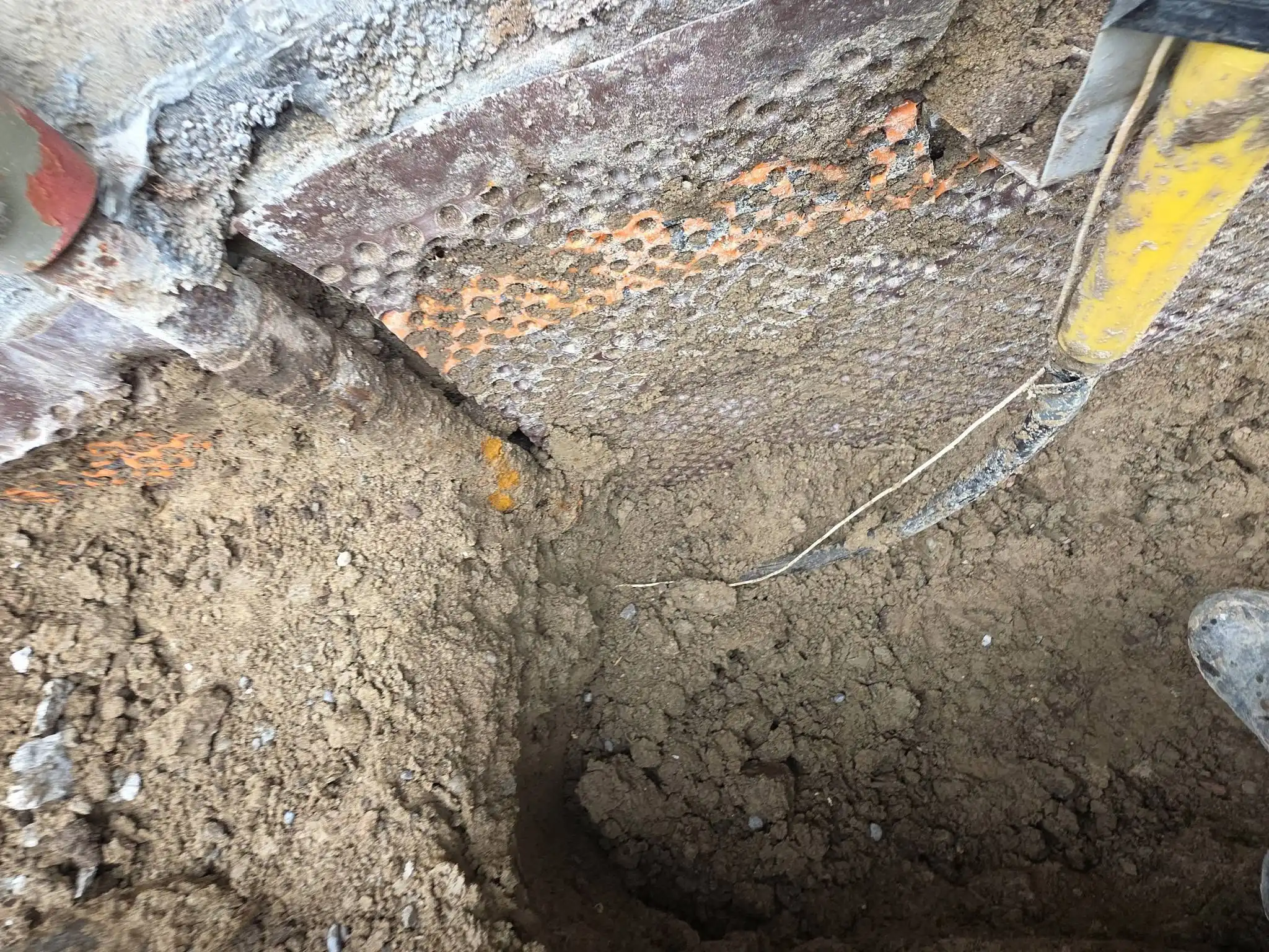 Excavation exposing the footing and foundation of an older Toronto home during repair